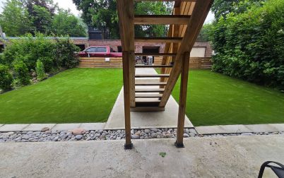backyard in Toronto with artificial grass installed around walkway